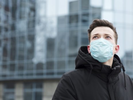 Man with medical mask in city