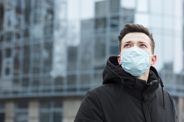 Man with medical mask in city