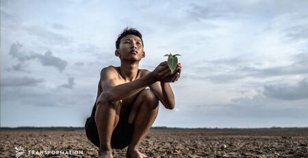 climate change, dirt, a person holding a plant | Transformation Holdings