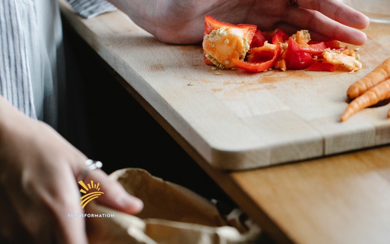 person throwing tomato waste